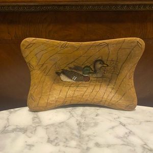 Brown wooden bowl with ducks carved and painted.